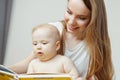 Mother reading to little infant colorful book with fairy tales. Royalty Free Stock Photo