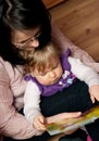 Mother reads to baby daughter