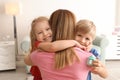 Mother receiving gift from her cute little children at home Royalty Free Stock Photo