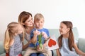 Mother receiving gifts from her cute little children at home Royalty Free Stock Photo