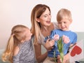 Mother receiving gifts from her cute little children at home Royalty Free Stock Photo