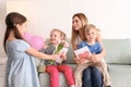 Mother receiving gifts from her cute little children at home Royalty Free Stock Photo