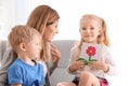 Mother receiving greeting card from her cute little children at home Royalty Free Stock Photo