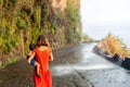 Mother in a red dress with her son at Anjos Waterfall, Madeira