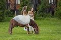 mother rides her daughter on a pony Royalty Free Stock Photo