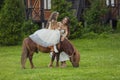 mother rides her daughter on a pony Royalty Free Stock Photo