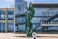 The Mother River statue on the riverfront along the Mississippi River with buildings in New Orleans Louisiana