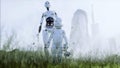 Mother robot with her baby robot in the meadow on the background of a futuristic city. Family of the future. Robofamily