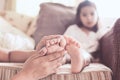 Mother is rubbing the barefeet of sick asian child girl Royalty Free Stock Photo