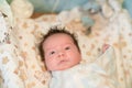 Mother rubs baby after bathing. the boy smiles and feels happy after taking a bath. mother dries and rubs the hair of the newborn Royalty Free Stock Photo