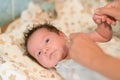 Mother rubs baby after bathing. the boy smiles and feels happy after taking a bath. mother dries and rubs the hair of the newborn