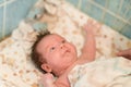 Mother rubs baby after bathing. the boy smiles and feels happy after taking a bath. mother dries and rubs the hair of the newborn Royalty Free Stock Photo