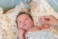 Mother rubs baby after bathing. the boy smiles and feels happy after taking a bath. mother dries and rubs the hair of the newborn Royalty Free Stock Photo