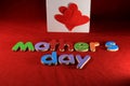 Mother`s Day alphabet blocks arranged on red background. Mother`s day gift box. Mother`s day concept.