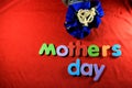 Mother`s Day alphabet blocks arranged on red background. Mother`s day gift box. Mother`s day concept.