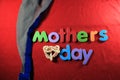Mother`s Day alphabet blocks arranged on red background. Mother`s day gift box. Mother`s day concept.