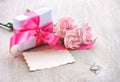 Mother`s Day background, gift box, three pink carnations, paper Royalty Free Stock Photo