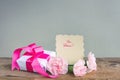 Mother`s Day background, gift box, three pink carnations