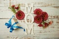 Mother`s day background with Mom alphabet letters and Flowers and gift box on wooden background Royalty Free Stock Photo