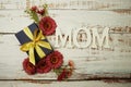 Mother`s day background with Mom alphabet letters and Flowers and gift box on wooden background Royalty Free Stock Photo