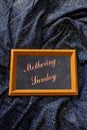 Mother`s Day composition. Text on a chalk board lying on a shiny lurex fabric Royalty Free Stock Photo