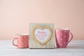 Mother`s day concept with photo heart shape frame and coffee cup on wooden table Royalty Free Stock Photo