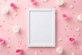 Top view photo of photo frame white and pink rose buds small hearts and sprinkles on pastel pink background with copyspace Royalty Free Stock Photo