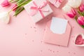 Top view photo of gift boxes bunches of pink and white tulips open envelope with letter and heart shaped saucer with sprinkles