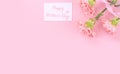 Mother`s Day design concept - Pink carnations on a pale pink background with gratitude greeting card and words, top view, flat la