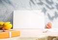 Mother`s Day elegant postcard mockup with envelope, flowers and a gift on a textured wall. Modern greeting card background for