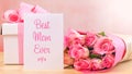 Mother`s Day gift, pink roses and Best Mom Ever greeting card on table. Royalty Free Stock Photo