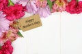 Mother's Day gift tag with flower corner border on white wood