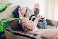 Mother`s day. Mother and her adult daughter applied facial masks at home. Women chilling while having wine Royalty Free Stock Photo