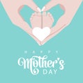 Mother\'s day mother\'s hands hold the legs of the baby she loves in green and white colors