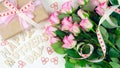 Mother`s Day overhead with gift and pink roses on white wood table background Royalty Free Stock Photo