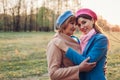 Mother`s day. Senior mother and her adult daughter hugging outdoors. Family values. Women walking in spring park Royalty Free Stock Photo