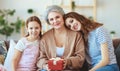 Mother`s day! three generations of  family mother, grandmother and daughter congratulate on the holiday, give flowers Royalty Free Stock Photo