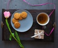 Mother`s Day, woman`s day. tulips , presents , tea and sweets on wooden background Royalty Free Stock Photo