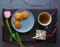 Mother`s Day, woman`s day. tulips ,presents ,tea and sweets on wooden background Royalty Free Stock Photo