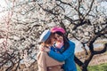 Mother`s day, Women`s day. Senior mother and her adult daughter hugging in spring blooming park. Family values Royalty Free Stock Photo