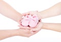 Mothers and fathers hands holding baby booties Royalty Free Stock Photo