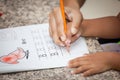 Mother's hand holding child hand writing her homework Royalty Free Stock Photo