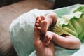 Mother`s hand touching tiny feet of newborn baby. Togetherness, new life. Royalty Free Stock Photo