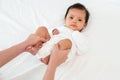 mother's hands holding baby legs and doing some playful exercises on bed Royalty Free Stock Photo