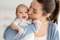 Mother& x27;s Love. Closeup Portrait Of Young Mom Kissing Her Cute Newborn Child Royalty Free Stock Photo