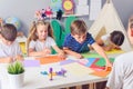 Mother or school teacher with children. Creative arts and crafts project at school or at home. Royalty Free Stock Photo