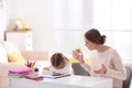 Mother scolding her daughter while helping with homework