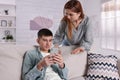 Mother scolding her son while he using smartphone at home. Teenager problems Royalty Free Stock Photo