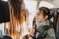 Mother securing her toddler daughter buckled into her baby car seat Royalty Free Stock Photo