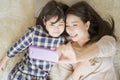 Mother is selfie with her little daughter using a smart phone camera with daughter .Asian family concept. Royalty Free Stock Photo